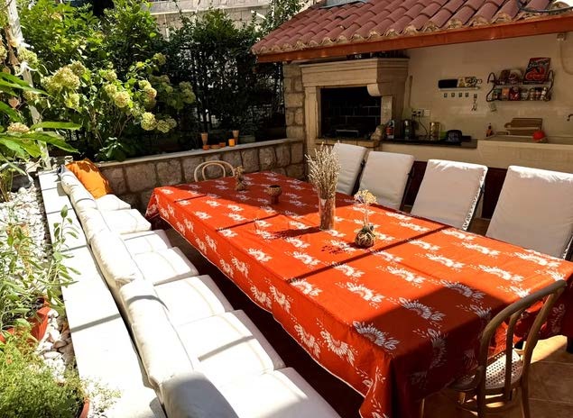 Wild Orange garden dining table with outdoor kitchen and grill